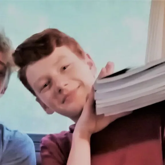 Wolsey Hall Oxford students, Sebastian, Aiden, and Ella with their textbooks.