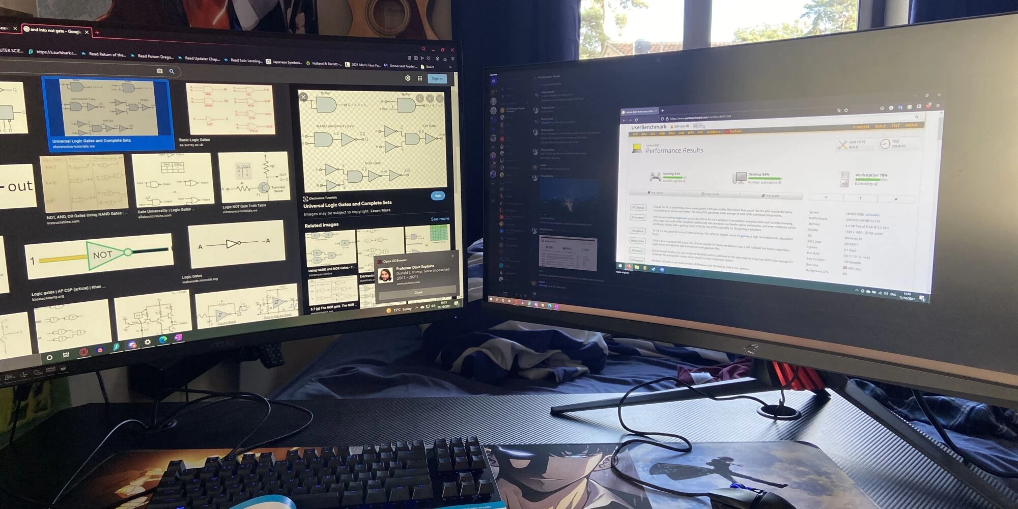 A desk with two large computer monitors displaying educational content, a keyboard, and a mousepad, indicating an organised study space.