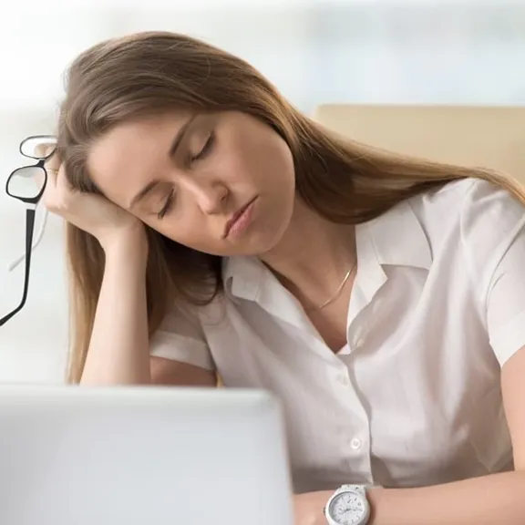 Older teenage girl asleep at her desk.