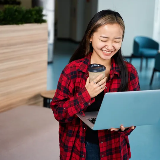 A blurry, long-exposure photo of people moving quickly on and around escalators in a bright, modern corporate or public building, symbolizing the fast pace of business management.