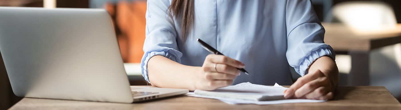 Tutor engaging in note-taking for their online students.