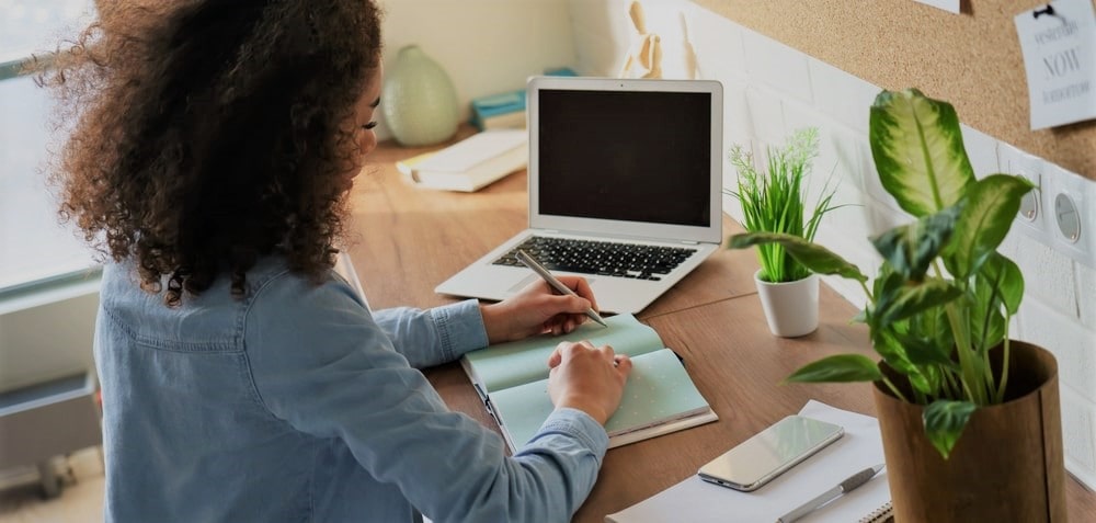 Older female student creating a list. 