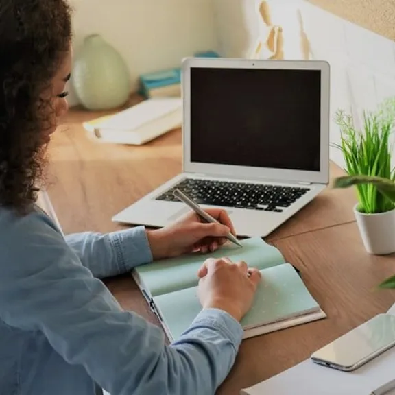Older female student creating a list.