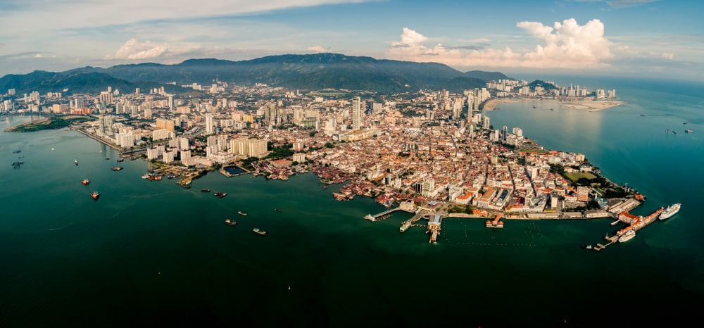 Aerial panoramic view of Penang, Malaysia, showcasing the cityscape, coastline, and hills, offering a glimpse into the environment for homeschooling families.