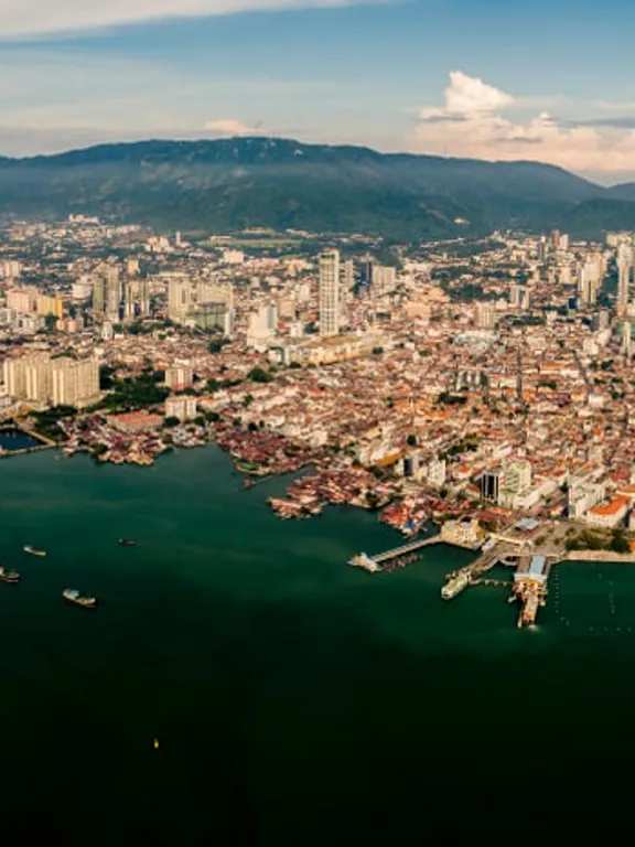 Aerial panoramic view of Penang, Malaysia, showcasing the cityscape, coastline, and hills, offering a glimpse into the environment for homeschooling families.