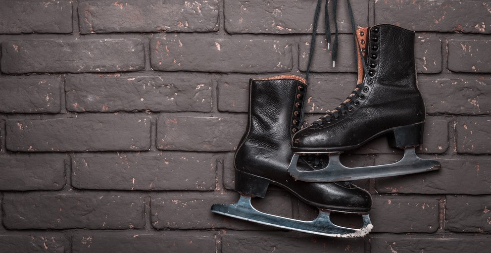 Black ice skates hanging up. 