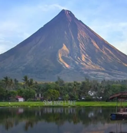 Landscape view of a stand alone Filipino mountain, with a very scenic sky and a green foreground.