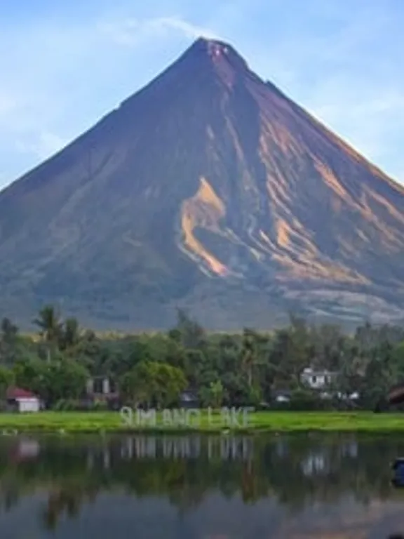 Landscape view of a stand alone Filipino mountain, with a very scenic sky and a green foreground.