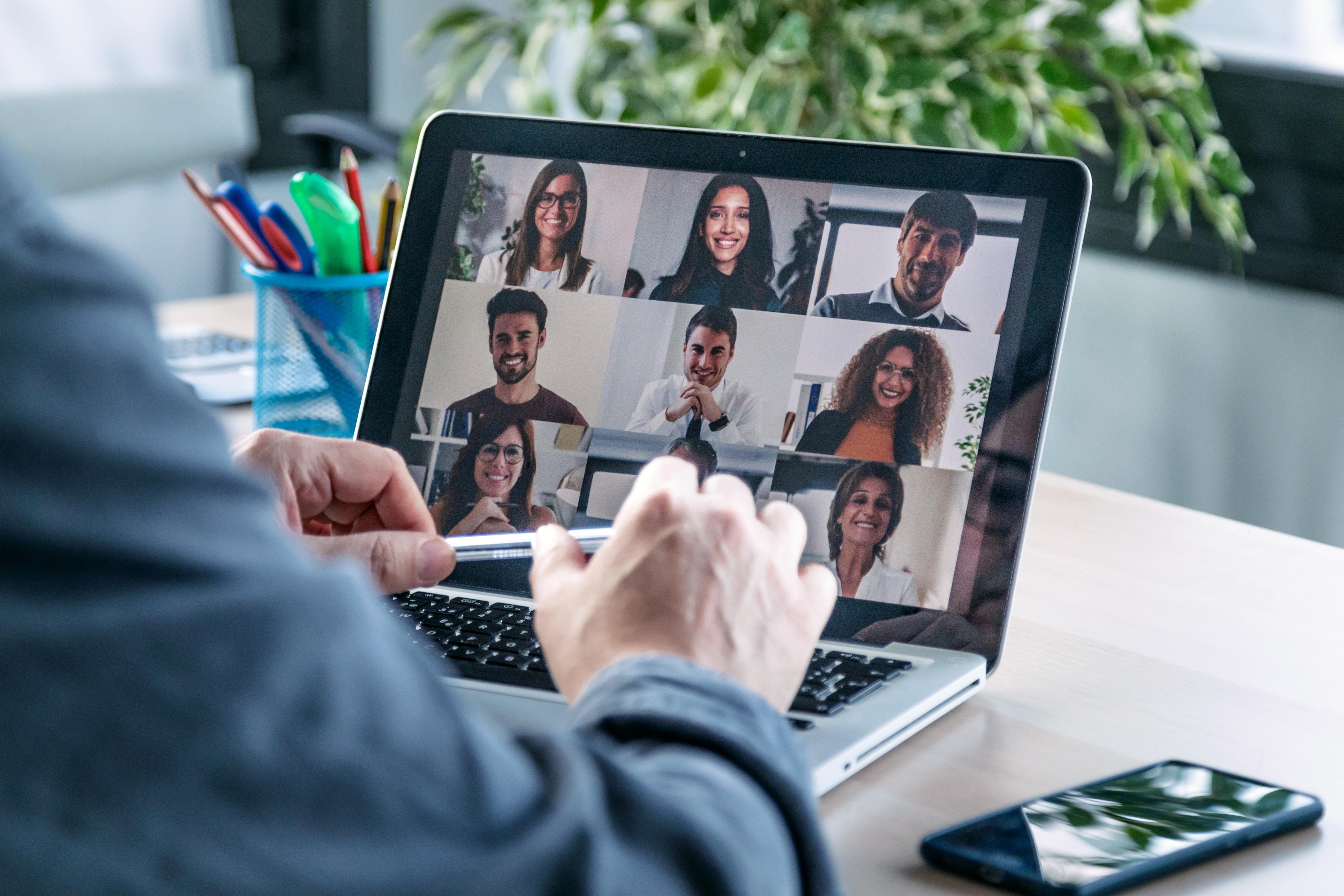 A team of online education professionals collaborating during a video conference call.