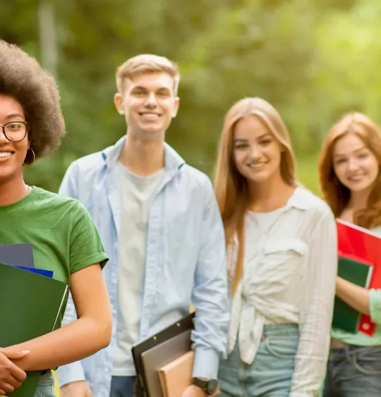 GCSE Level students in a row smiling towards the camera.