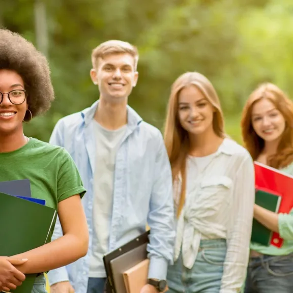 GCSE Level students in a row smiling towards the camera.
