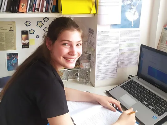 Wolsey Hall Oxford student, Sofia, working at her desk.