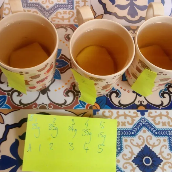 A line of drinking mugs with different measurements in front of them.