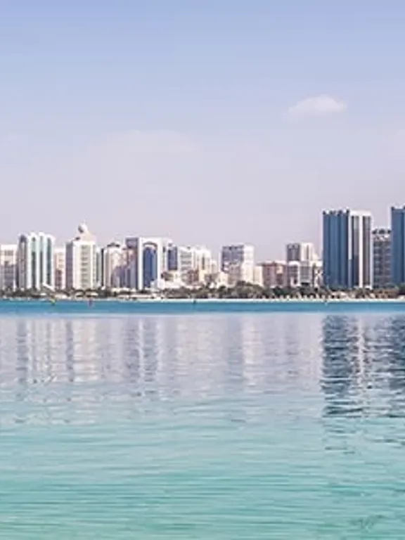 Skyline of Abu Dhabi reflected in clear turquoise water, representing global learning opportunities