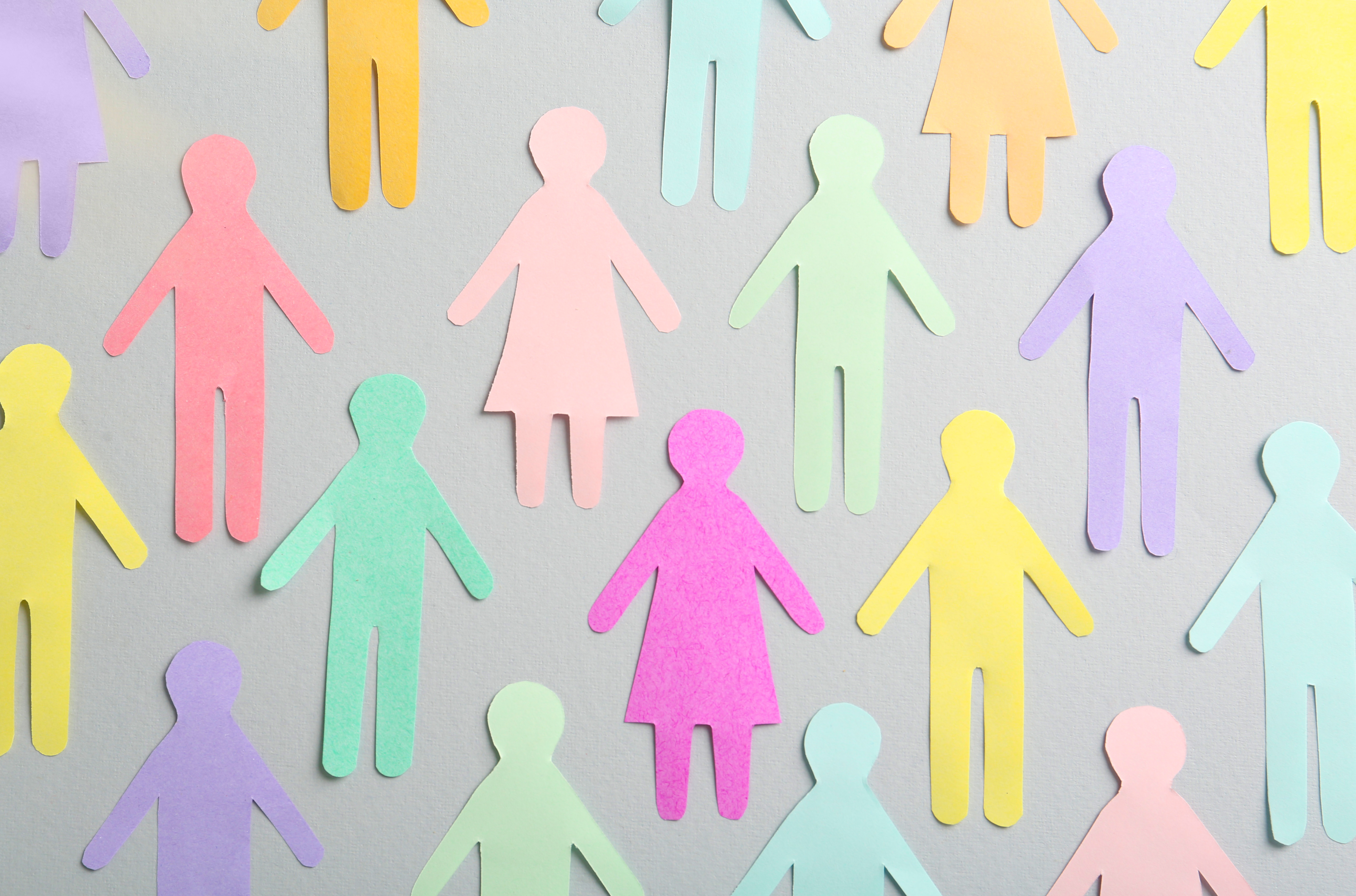 Cutouts of different coloured paper people. 