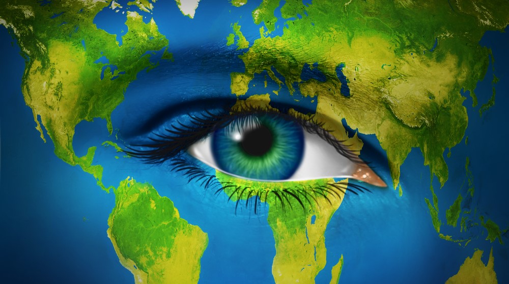 Artistic illustration of a human eye blended into a world map, symbolising global awareness.