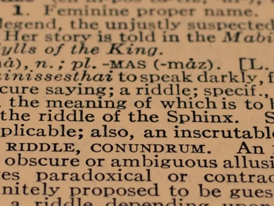 Close up of 'enigma' definition, highlighting the importance of language.