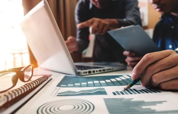 Economics students studying economic charts. 