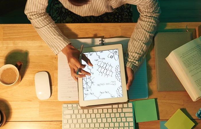 Studying chemistry symbols and equations on a tablet. 