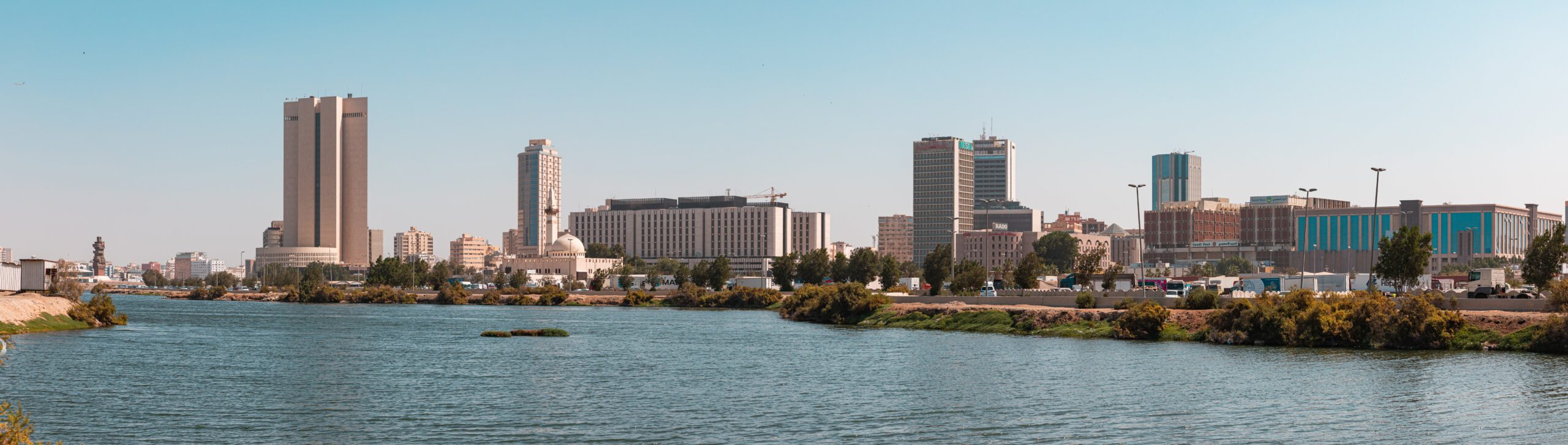 Panoramic view of the Jeddah skyline with its distinctive buildings along the waterfront, illustrating the urban setting for homeschooling in the city.