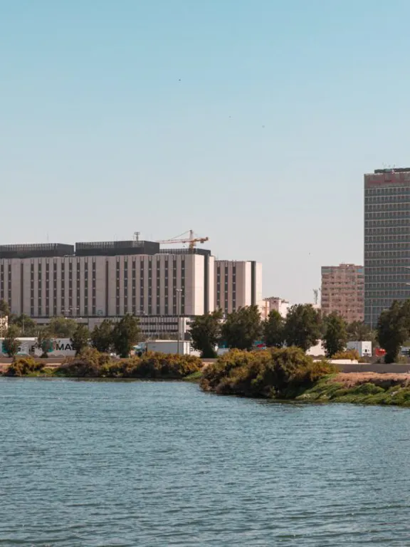 Panoramic view of the Jeddah skyline with its distinctive buildings along the waterfront, illustrating the urban setting for homeschooling in the city.