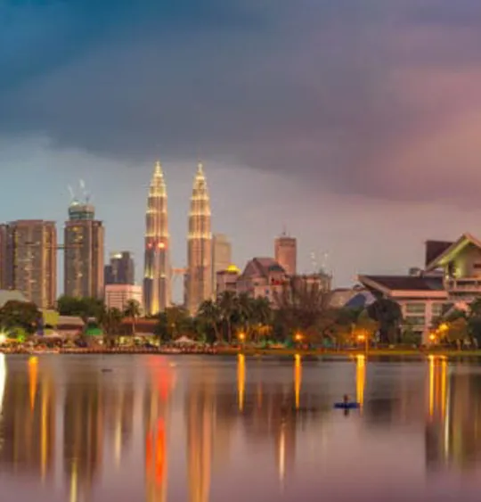 Landscape view of the Kuala Lumpur skyline, with a scenic and colourful sky.