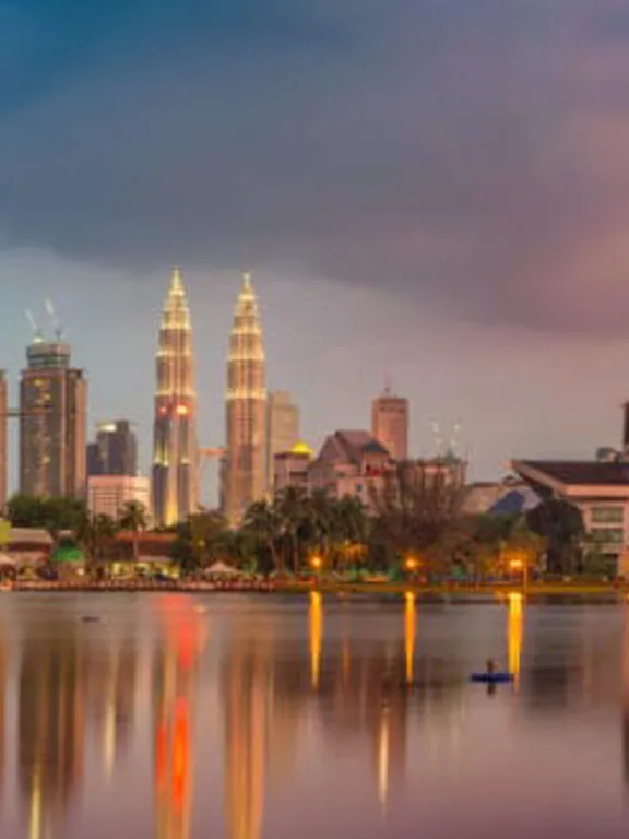 Landscape view of the Kuala Lumpur skyline, with a scenic and colourful sky.