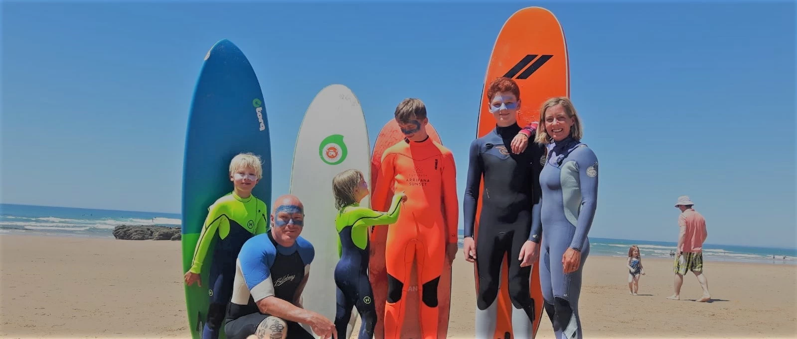 Family photo of the Binedells getting ready to surf. 