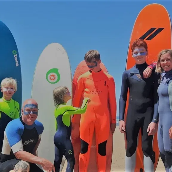 Family photo of the Binedells getting ready to surf.