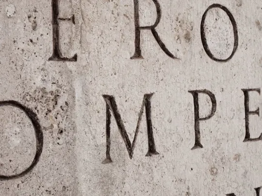 Old stone engraved with latin words.