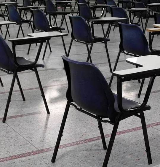 Chairs and desks in an exam hall.
