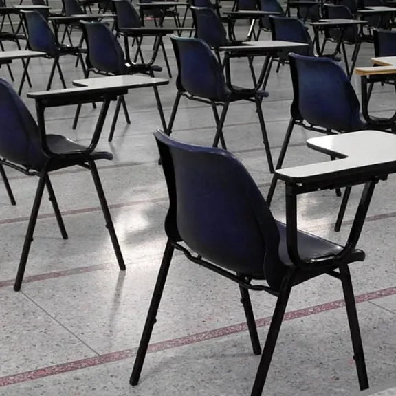 Chairs and desks in an exam hall.