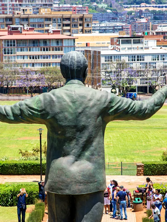 The iconic Nelson Mandela statue with arms outstretched at the Union Buildings in Pretoria, a significant site for educational outings for homeschooling families.