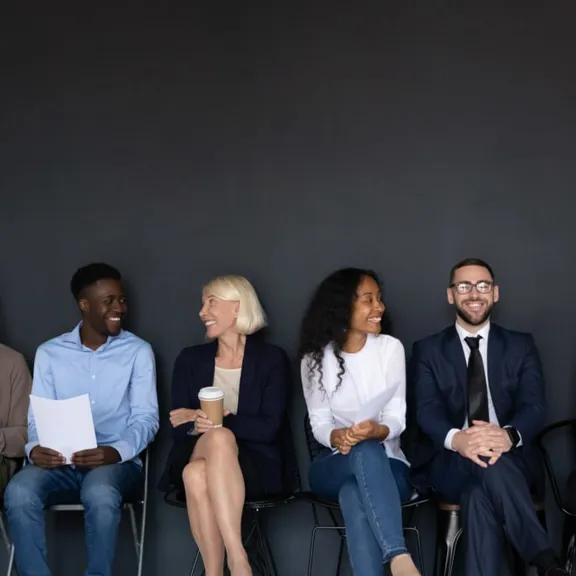 Row of adults all sat in a line.