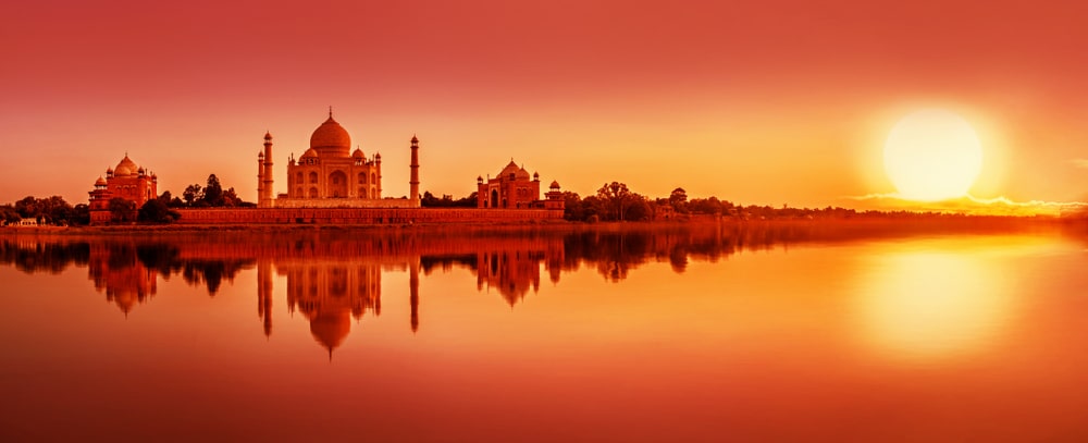 The Taj Mahal, at sunset from across a river. 