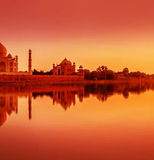 The Taj Mahal, at sunset from across a river.