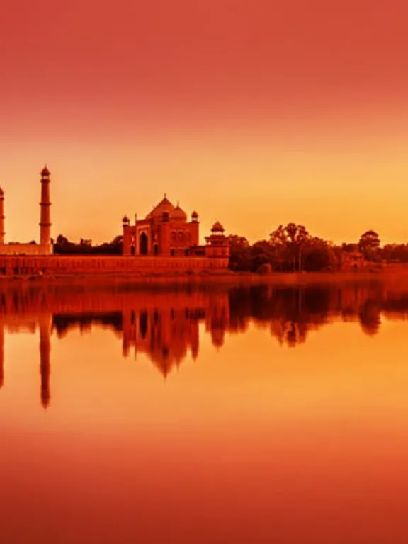 The Taj Mahal, at sunset from across a river.