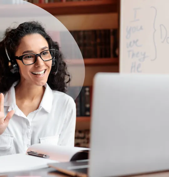 A friendly and approachable online tutor with a headset on, ready to help students succeed.