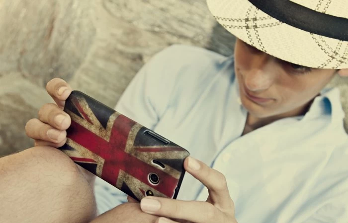 Someone using their phone with a Union Jack phone case. 
