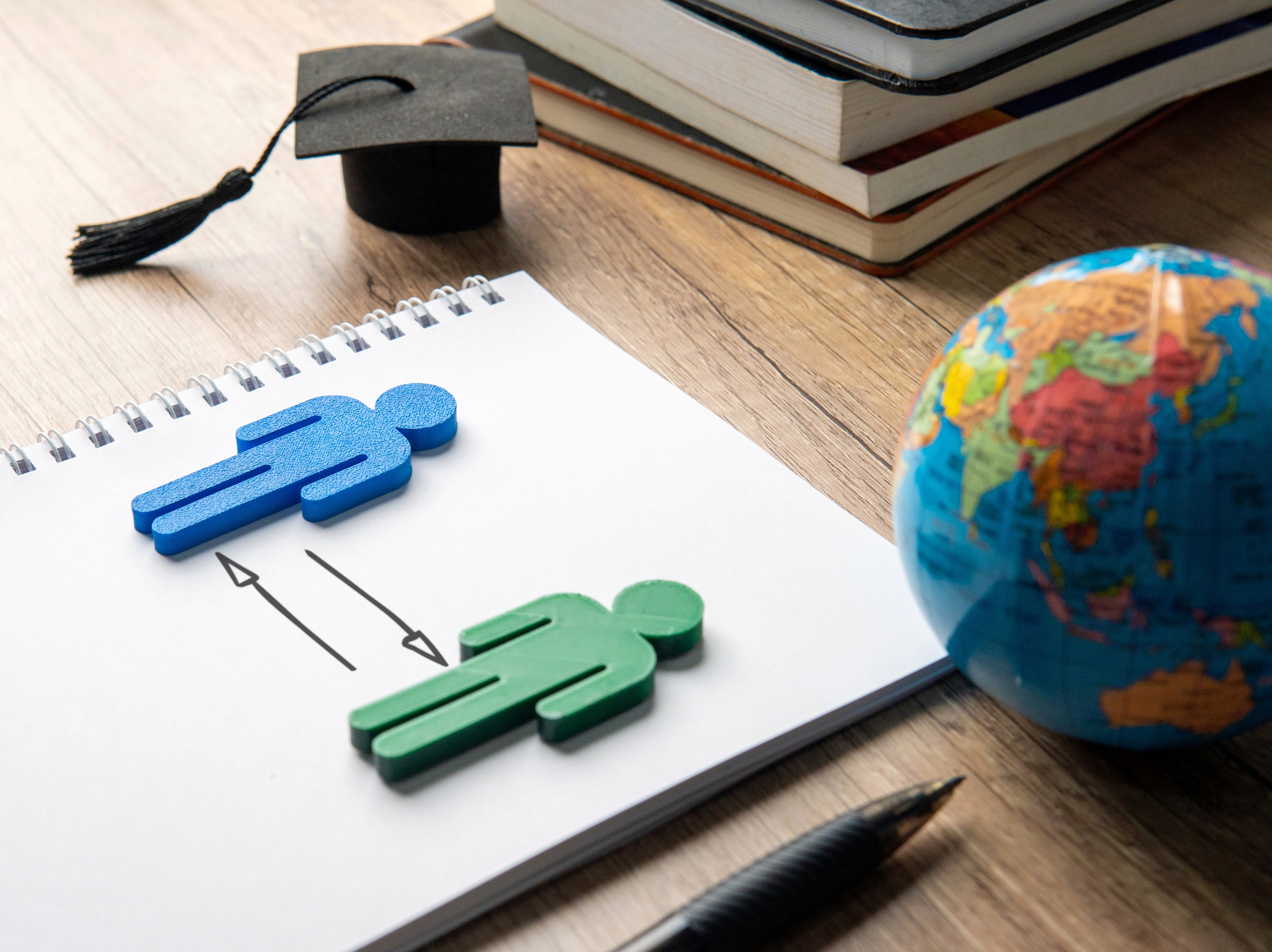 Wooden people on a piece of paper. 