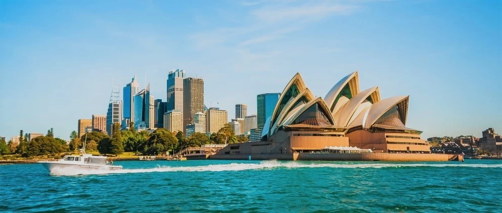 A landscape view of the Sydney Opera House, and the surrounding skyline. 