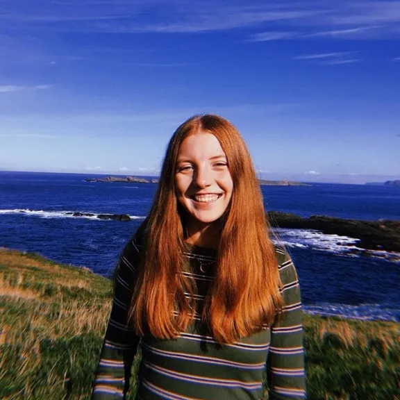 Wolsey Hall Oxford student, Lucy, stood on a cliff over looking the sea.