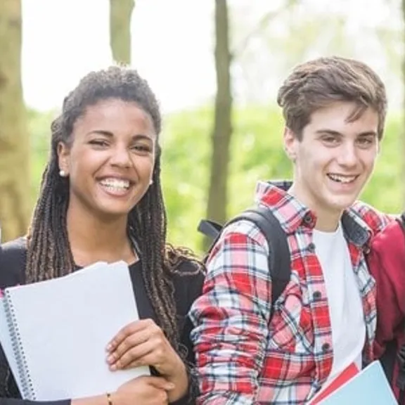 A group of teenagers smiling at the camera.