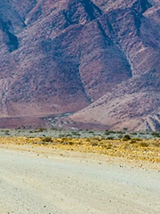 A cyclist on a long straight road.