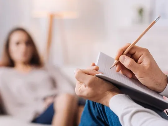 A close up of a therapists note pad, when they are in session with one of their patients.