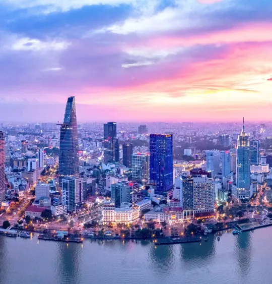 Landscape of a Vietnamese skyline with a very pink and blue sunset.