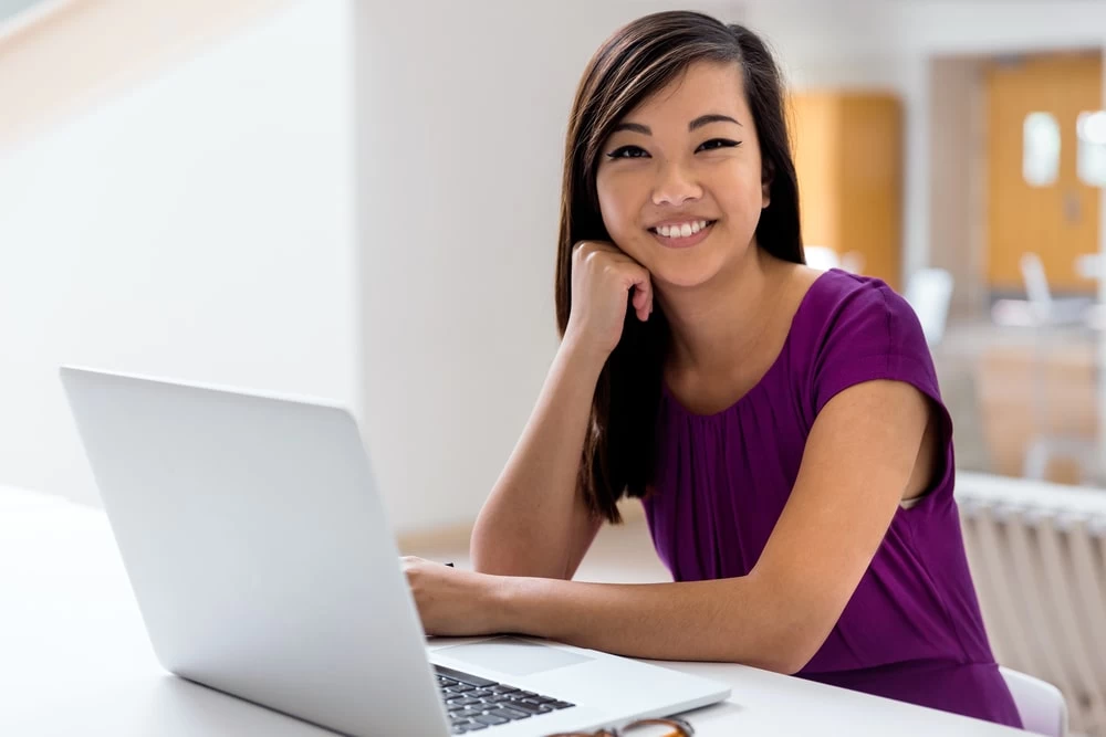 An older woman business student, studying at her laptop. 