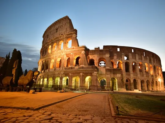 Landscape view of the Roman Colosseum at night.