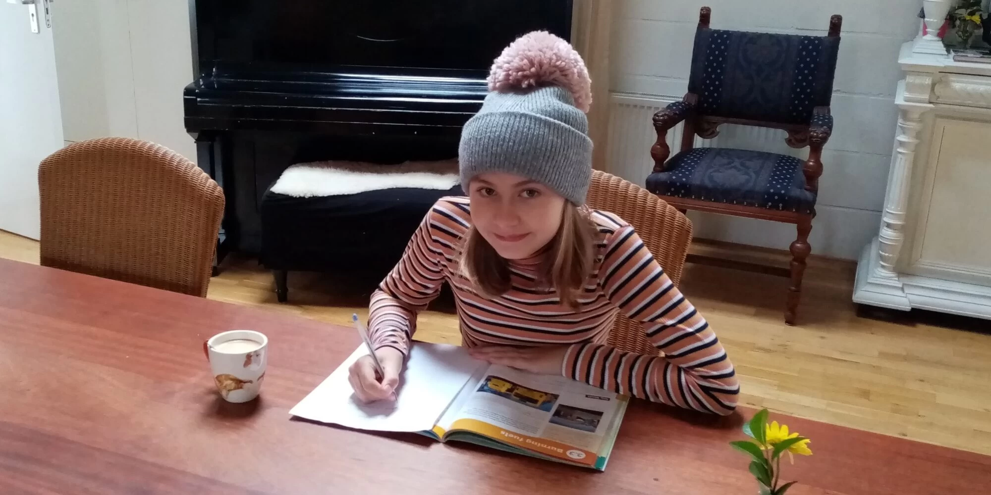 Wolsey Hall Oxford student, Ella, working at a table. 
