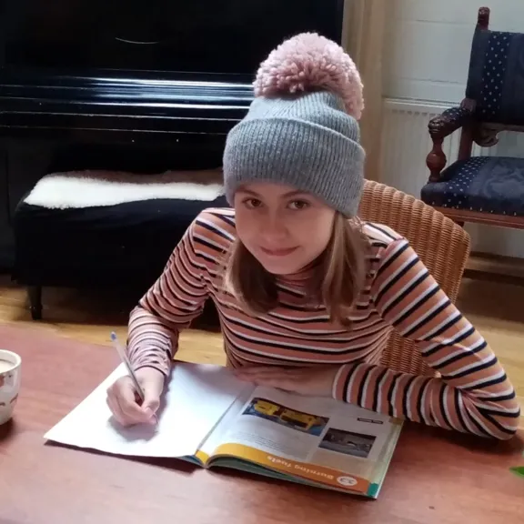 Wolsey Hall Oxford student, Ella, working at a table.